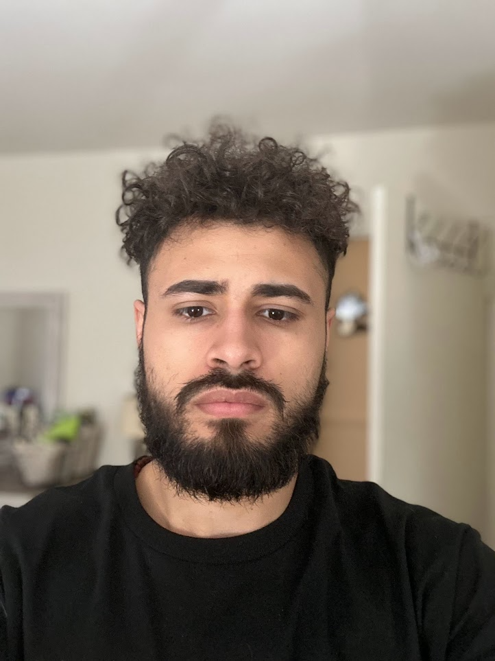 Close portrait of Angel against a softly blurred interior background.